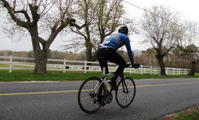 Cyclist riding down road