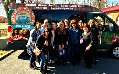 Group of people standing in front of Delmarva Discovery van